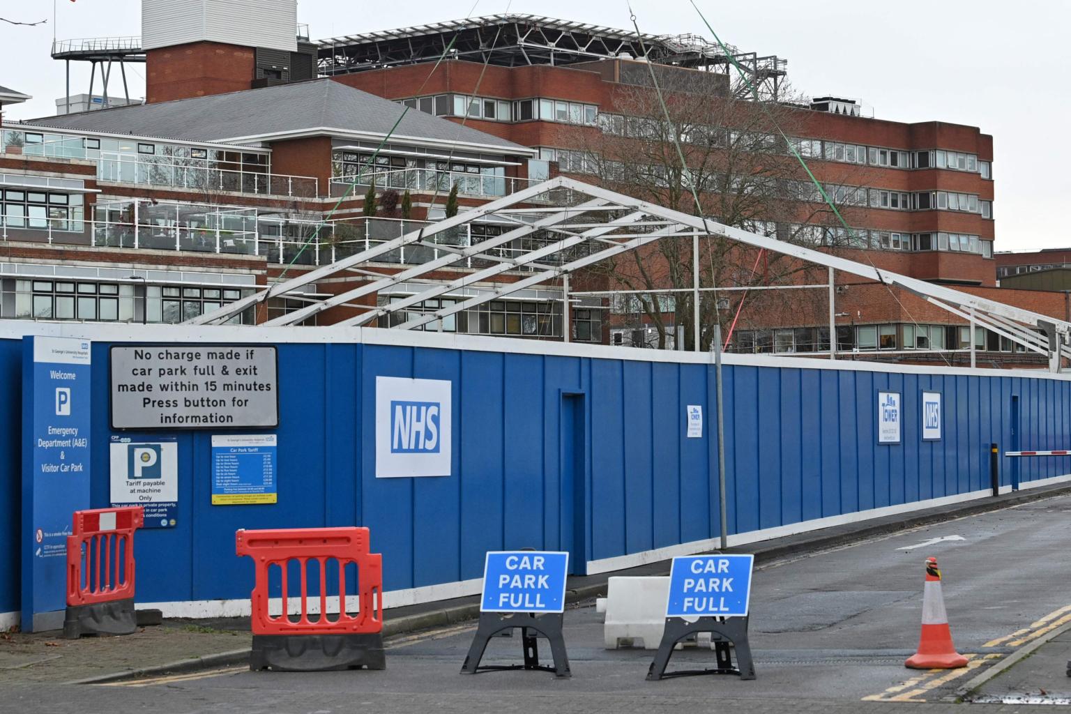 As virus surges, England builds temporary hospitals